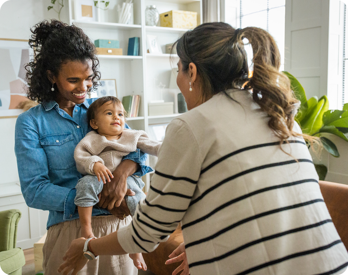 Friends enjoying time with a baby